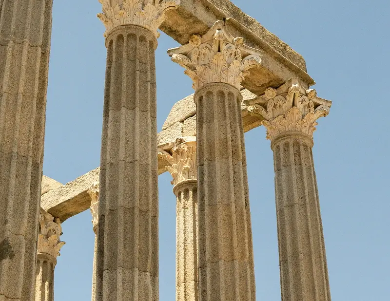 Corinthian columns of the Roman Temple of Evora against a clear sky