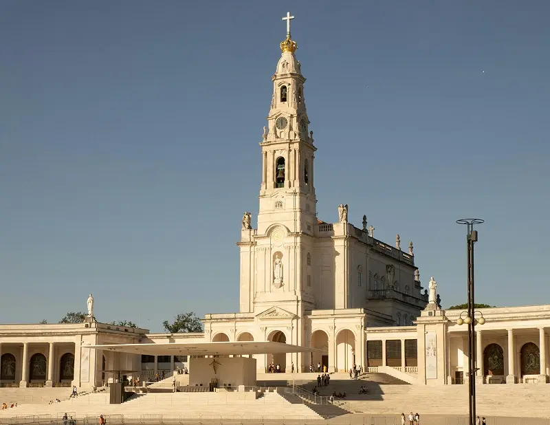 The basilica and bell tower of the Sanctuary of Fatima seen across the square