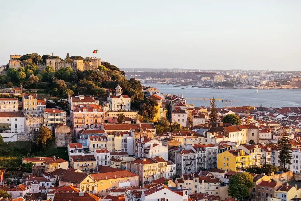 Sao Jorge Castle above the rooftops of Alfama at sunset, Lisbon