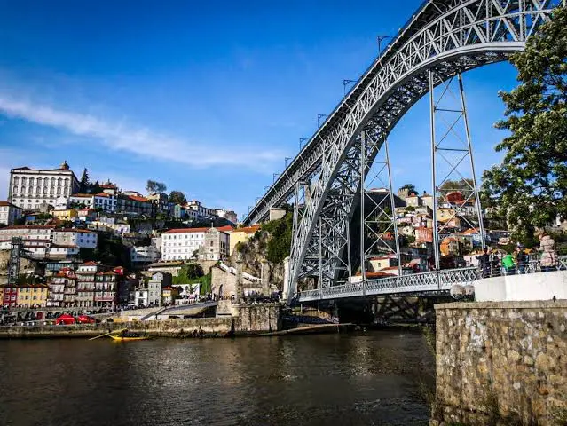 Dom Luis I Bridge over the Douro, with rabelo boats moored in Ribeira, Porto