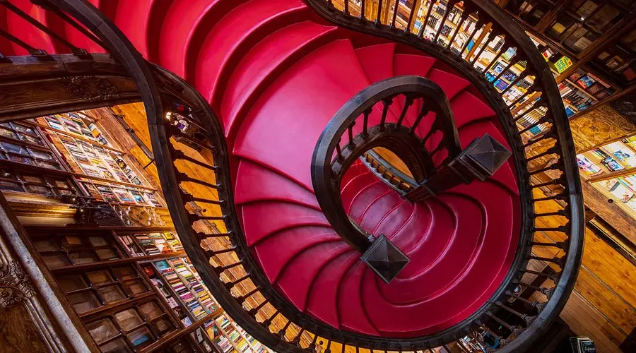 The crimson staircase inside Livraria Lello bookshop in Porto